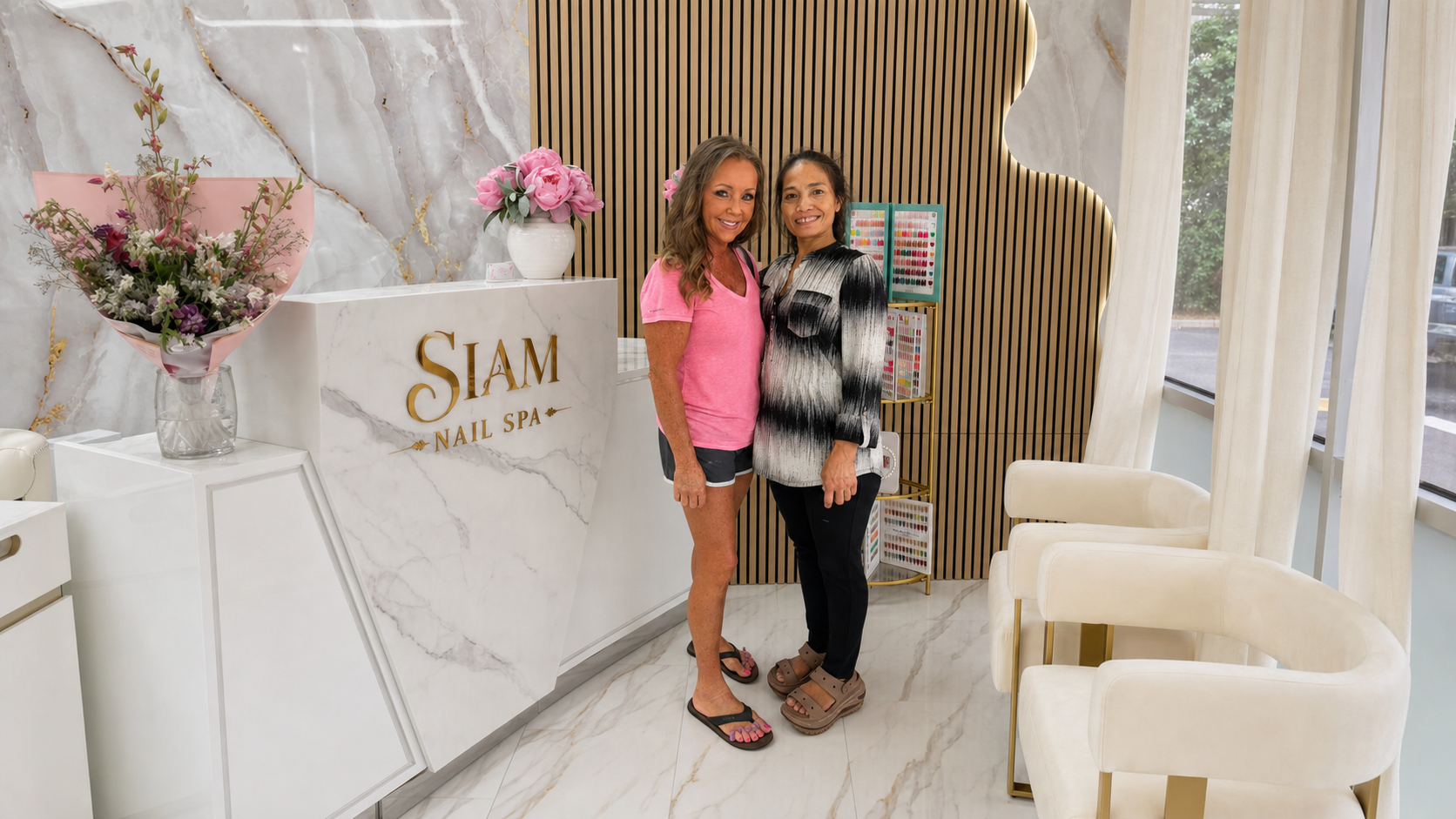 Siam Nail Spa's first guest with a member of the salon team at the real Belmont front desk